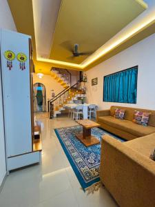 a living room with a couch and a table at Tranquil Trails-Suprabha Villa-Nashik in Nashik