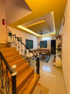 a staircase in a house with a living room at Tranquil Trails-Suprabha Villa-Nashik in Nashik