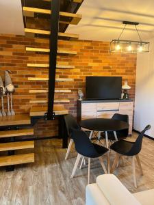 a living room with a table and chairs at Nest Haus in Ludwikowice Kłodzkie