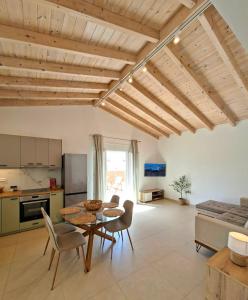 a kitchen and living room with a table and chairs at Villa Eleni Apartment no2 in Agios Gordios