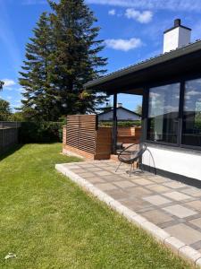 a bench sitting on a patio next to a house at House with a lovely location in Børkop