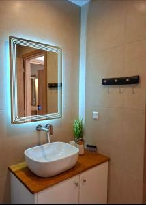 a bathroom with a sink and a mirror at Villa Eleni Apartment no2 in Agios Gordios