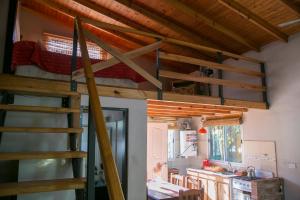 a loft bed in a room with a kitchen at El Solar in Vuelta de Obligado