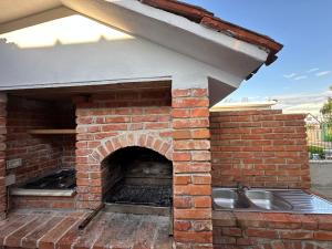 a brick pizza oven with a sink in it at Garden Beach House in Hamallë