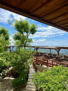 a patio with tables and a view of the ocean at Rooms Merlika -Inside the Castle- in Krujë