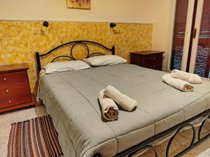 a bedroom with a large bed with towels on it at Vanilla House Paleokastritsa in Paleokastritsa