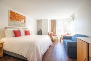 a bedroom with a bed and a blue couch at Rum Runner Inn in Lunenburg