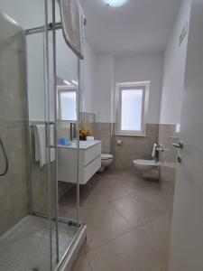a bathroom with a shower and a sink and a toilet at Albergo Athena Mare in Sibari +31 photos
