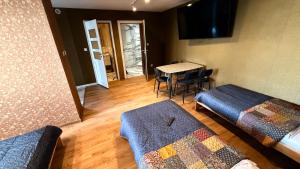 a room with two beds and a table with chairs at Noclegi lebudbis in Wąchock