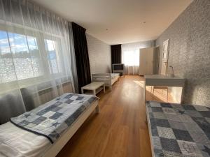 a bedroom with two beds and a desk and a window at Noclegi lebudbis in Wąchock
