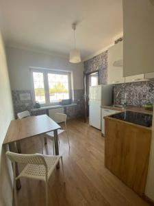 a kitchen with a table and chairs and a table and a kitchen with a counter at Noclegi lebudbis in Wąchock