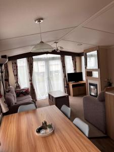 a living room with a table and a couch at Seton Sands in Port Seton