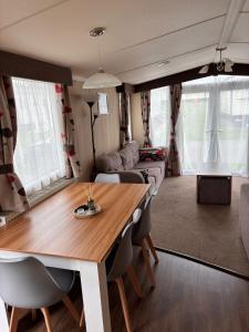 a dining room and living room with a table and chairs at Seton Sands in Port Seton