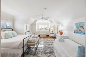 a white bedroom with two beds and a window at Serenity Now in Rosemary Beach +36 photos