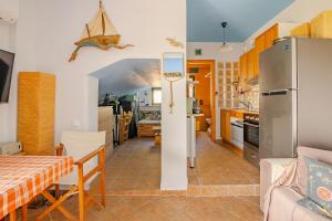 a kitchen and dining room with a refrigerator and a table at Fragola in Pefkali +25 photos