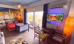 a living room with a room with a bedroom at Fragola in Pefkali