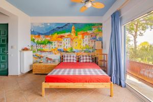 a bedroom with a painting on the wall at Fragola in Pefkali