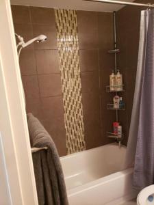 a bathroom with a shower and a bath tub at Parson Creek Cozy suite in Fort McMurray +13 photos