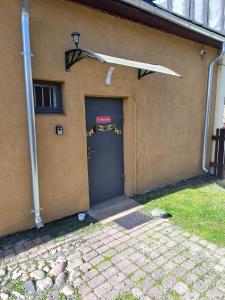 a garage with a door with a sign on it at Tirgus nams in Ventspils