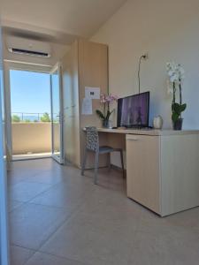 an office with a desk with a computer and a window at Albergo Athena Mare in Sibari