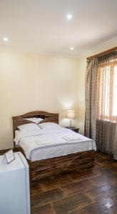 a bedroom with a large bed and a window at Hotel Nirvana in Dilijan