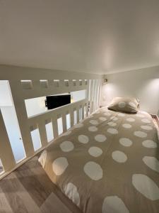 a bedroom with a large bed in a room at Le Nid d'escale in Tillé