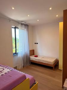 a bedroom with two beds and a window at Oasi di Comago in Sant'Olcese