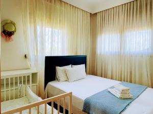 a small bedroom with a bed and a window at The Greek Mama's Cottage in Epanomi