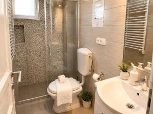 a bathroom with a toilet and a shower and a sink at Bonita Apartments in Mostar +23 photos