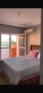 a bedroom with a large bed with a large window at Villa comfort in Bouznika +29 photos