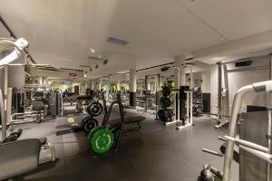 a gym with several treadmills and machines at Hi Hotels Trento - Wellness & Spa Adults Only in Trento