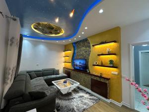 a living room with a couch and a tv at Prive Home in Maliq