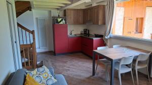 a kitchen and dining room with a table and chairs at Ledro Nest in Ledro