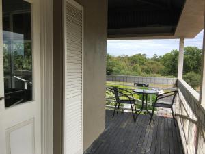 a porch with two chairs and a table on a balcony at Norwood House Motel & Receptions in Mornington
