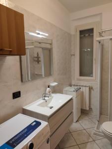 a bathroom with a sink and a toilet at Appartamento Rosa in Savio di Ravenna +18 photos