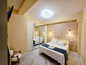 a bedroom with a large bed and a mirror at Chinatown Luxury Apartment in Madrid