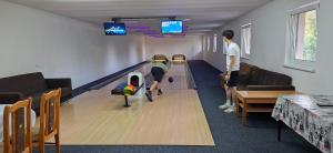 a man playing bowling in a bowling alley at PENZION EUROPA Diakovce in Diakovce