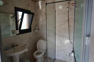 a bathroom with a shower and a toilet and a sink at Beni Rooms Tale in Tale +39 photos