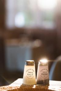 two jars of salt sitting on a table with a candle at Hotel Pazo de Bieite in Boimorto