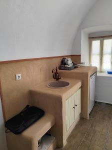 a bathroom with a sink and a counter top at Kamara Nest - More than a stay in Aroniadika