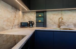 a kitchen with a counter top with a sink at Uus Street Apartment, Modern Stay near City Centre with Free Parking in Tartu