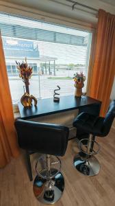 a desk with two stools in front of a window at SEA - 3 Bedrooms in Kristinestad