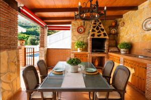 a dining room with a table and chairs at Villa Alabarce Nerja by Spain Sun Rentals in Nerja