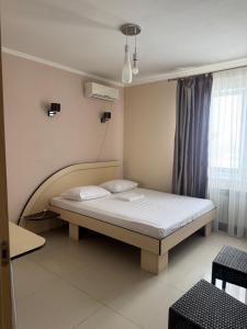 a bedroom with a bed in a room at Asteria in Odesa