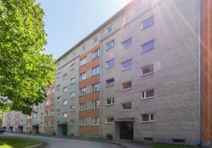 a large brick building on the side of a street at Uus Street Apartment, Modern Stay near City Centre with Free Parking in Tartu