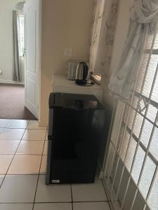 a kitchen with a black dishwasher in a room at Dee's 2 BR guest flat in Ladybrand in Ladybrand