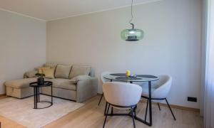 a living room with a couch and a table and chairs at Uus Street Apartment, Modern Stay near City Centre with Free Parking in Tartu +12 photos