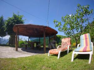 a group of chairs and a gazebo at Balocco Countryside Home 1908 - Barga in Sommocolonia