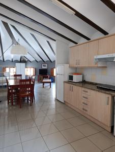 a kitchen and dining room with a table and chairs at Complejo Rural La Belluga in Segorbe