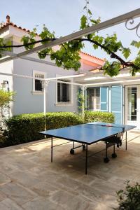 a ping pong table in front of a house at Villa Irini in Porto Heli